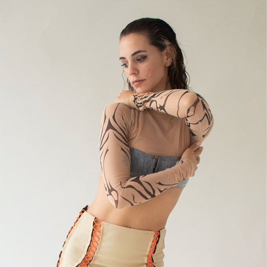 Skin colored mesh top with long raglan sleeves with tribal print