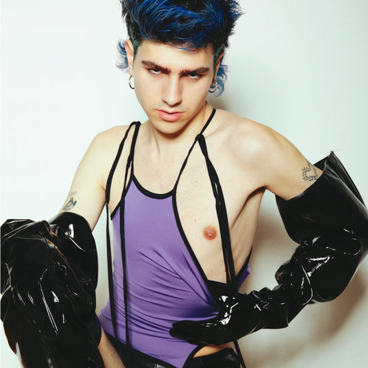 lilac top with laces, queer person with pvc hand gloves